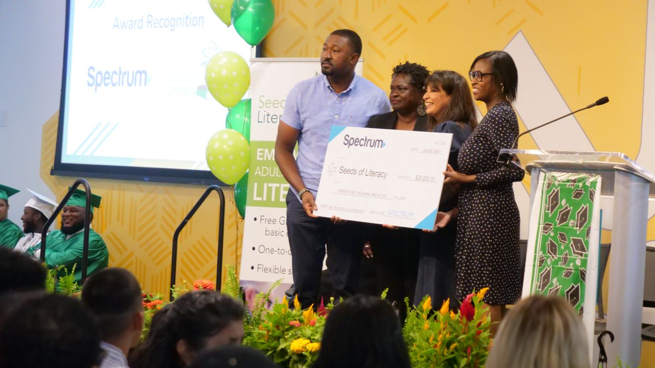 Spectrum awards a $25,000 check to Seeds of Literacy. 