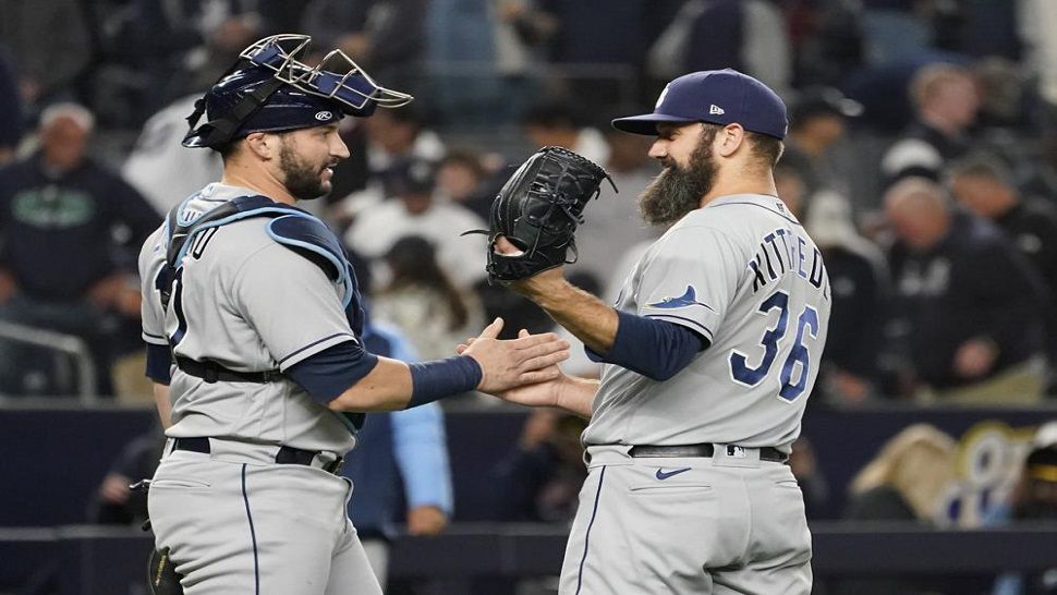 Tampa Bay Rays pitcher Andrew Kittredge (36) and catcher Mike Zunino celebrate after they defeated the New York Yankees 4-3.  The Rays improved to 99-61 this season. (AP Photo/Mary Altaffer)