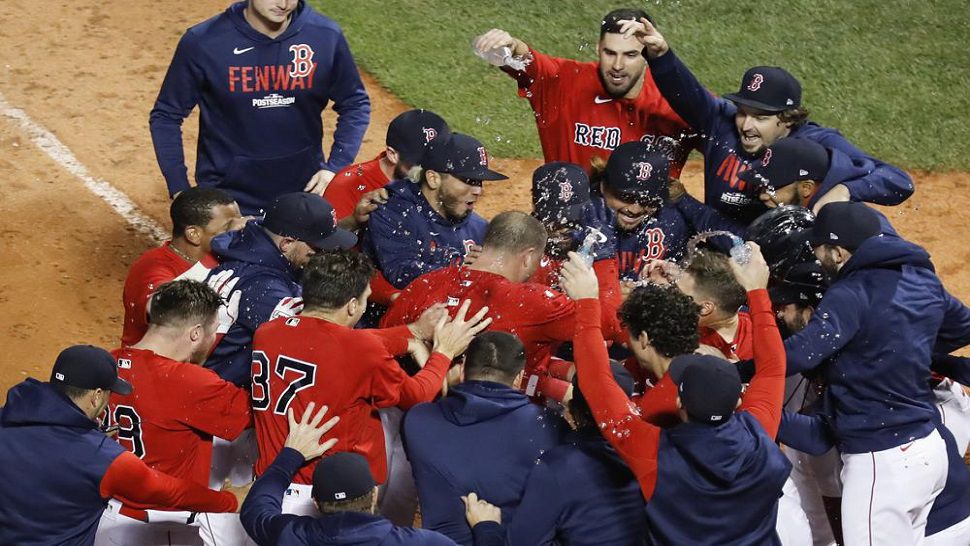 Boston Red Sox Christian Vazquez is mobbed by teammates after hitting a two-run walk-off home run during the thirteenth inning against the Tampa Bay Rays during Game 3 of the ALDS. Boston won 6-4 to take a 2-1 series lead. (AP Photo/Michael Dwyer)