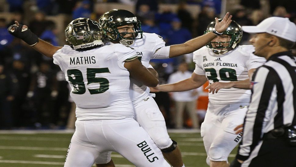 South Florida kicker Coby Weiss celebrates with teammates Jacob Mathis (85) and Trent Schneider (39) after kicking the go-ahead FG to beat Tulsa and help the Bulls improve to 6-0 for the second straight season (AP Photo/Sue Ogrocki)