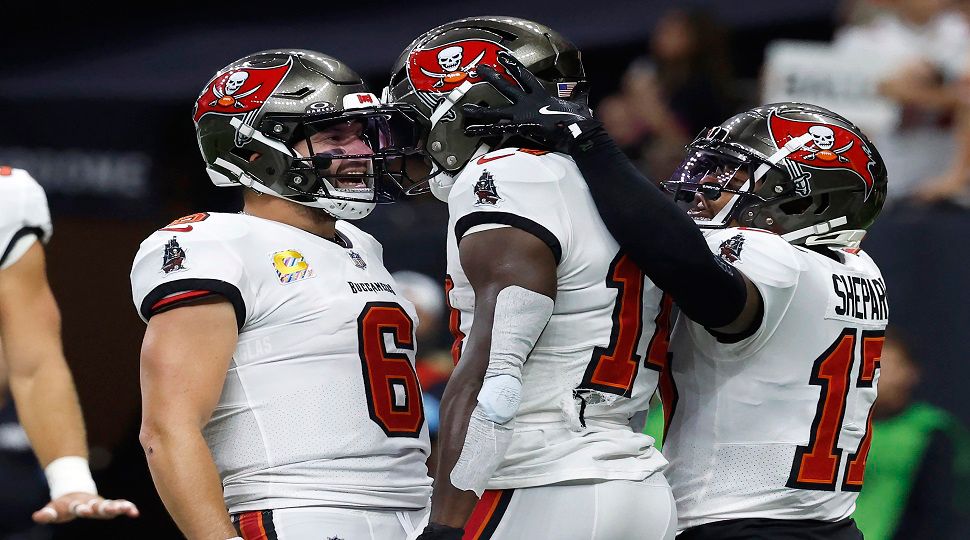 Tampa Bay Buccaneers wide receiver Chris Godwin, middle, is congratulated by quarterback Baker Mayfield (6) and wide receiver Sterling Shepard (17) after scoring against the New Orleans Saints during the first half of an NFL football game in New Orleans, Sunday, Oct. 13, 2024. (AP Photo/Butch Dill)