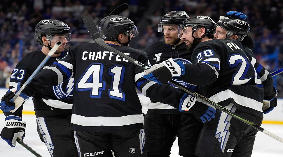 Tampa Bay Lightning right wing Mitchell Chaffee (41) celebrates his goal against the Washington Capitals with left wing Nick Paul (20), center Michael Eyssimont (23) and defenseman Erik Cernak (81) during the second period of an NHL hockey game Saturday, Oct. 26, 2024, in Tampa, Fla. (AP Photo/Chris O'Meara)