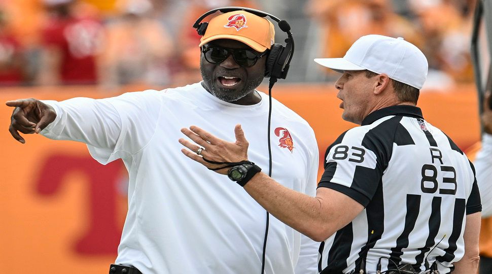 Tampa Bay Buccaneers head coach Todd Bowles speaks with referee Shawn Hochuli during the first half of an NFL football game against the Atlanta Falcons, Sunday, Oct. 27, 2024, in Tampa. (AP Photo/Jason Behnken)