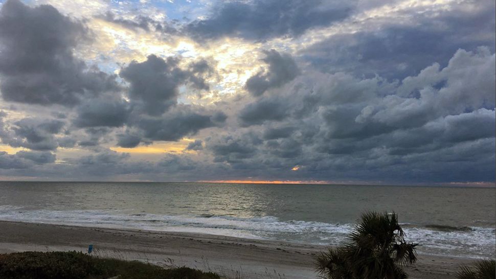 Submitted via the Spectrum News 13 app: Among a sky full of Clouds, a small line of bright light can be seen along the water on Saturday, October 27, 2018. (Courtesy of Barbara Scheible)