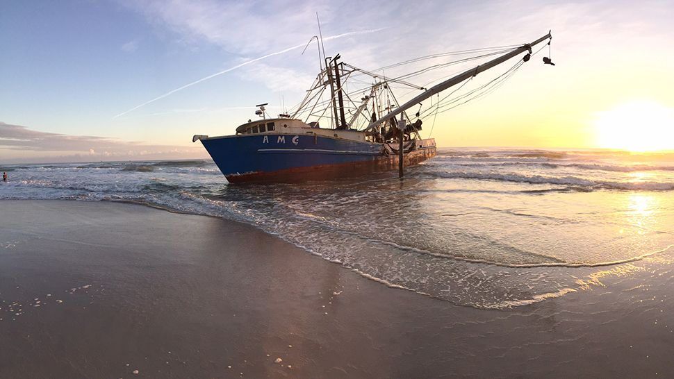 Submitted via the Spectrum News 13 app: A shrimp boat is seen beached at Ormond Beach at sunrise on Tuesday, October 30, 2018. (Courtesy of Tom Larsen)