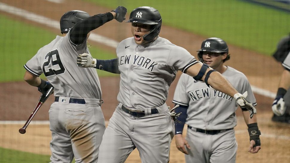 New York Yankees' Giancarlo Stanton, right, and third base coach