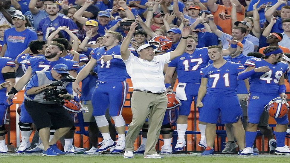 In this file photo, Florida Gators head coach Dan Mullen, center, celebrates with players on the sidelines during the final moments of the Gators upset victory over LSU. Mullen opened his first team meeting this week talking about handling success. He’ll find out Saturday if anyone was paying attention.(AP Photo/John Raoux, File)