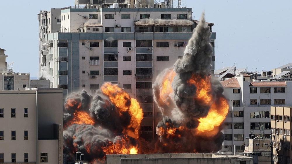 A ball of fire erupts from a building housing various international media, including The Associated Press, after an Israeli airstrike on Saturday, May 15, 2021 in Gaza City. (Mahmud Hams /Pool Photo via AP)