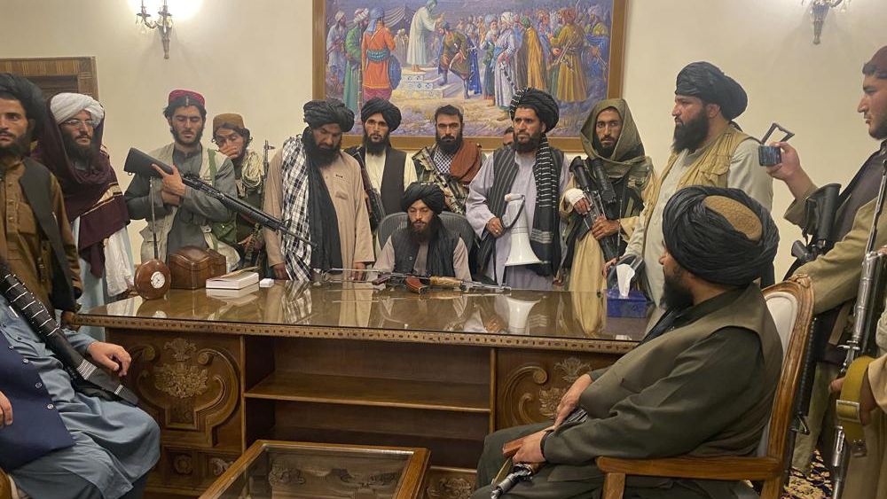 Taliban fighters take control of Afghan presidential palace after the Afghan President Ashraf Ghani fled the country, in Kabul, Afghanistan, Sunday, Aug. 15, 2021. (AP Photo/Zabi Karimi)