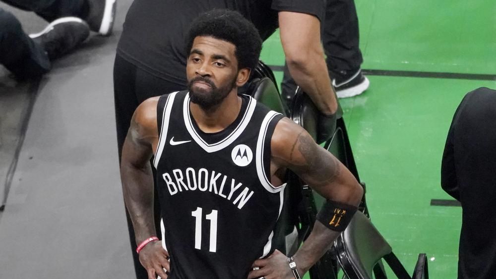 FILE - Brooklyn Nets guard Kyrie Irving looks up at the fans at TD Garden after they defeated the Boston Celtics in Game 4 during an NBA basketball first-round playoff series in Boston, in this Sunday, May 30, 2021, file photo. (AP Photo/Elise Amendola, File)