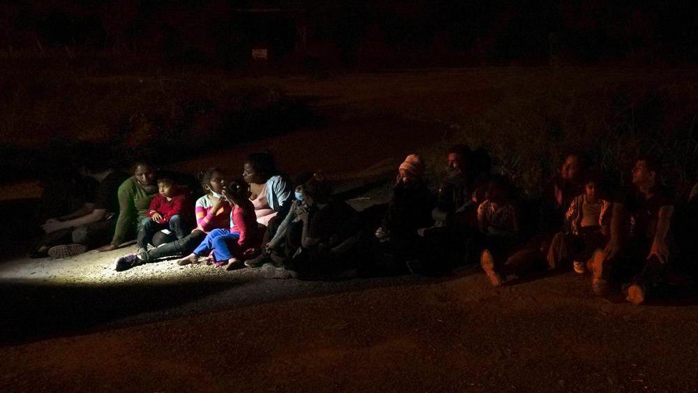 FILE - Migrants mainly from Honduras and Nicaragua seeking asylum sit in line after turning themselves in upon crossing the U.S.-Mexico border, in La Joya, Texas, May 17, 2021. The U.S. returned its first asylum-seekers under its “Migrant Protection Protocols” policy in the last week of January 2022 in Brownsville, Texas, the latest step in a slow-moving rollout across the border to make asylum hearings available to migrants who wait in Mexico. (AP Photo/Gregory Bull, File)