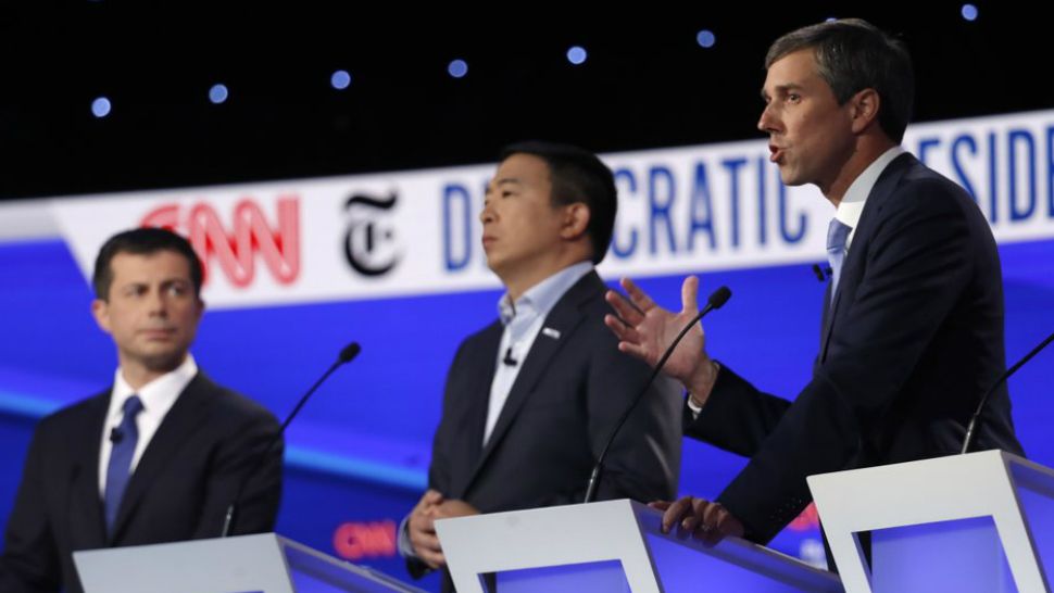 Democratic presidential candidate former Texas Rep. Beto O'Rourke, right, speaks as Democratic presidential candidate entrepreneur Andrew Yang, center and Democratic presidential candidate and South Bend Mayor Pete Buttigieg listen during a Democratic presidential primary debate hosted by CNN/New York Times at Otterbein University, Tuesday, Oct. 15, 2019, in Westerville, Ohio. (AP Photo/John Minchillo)