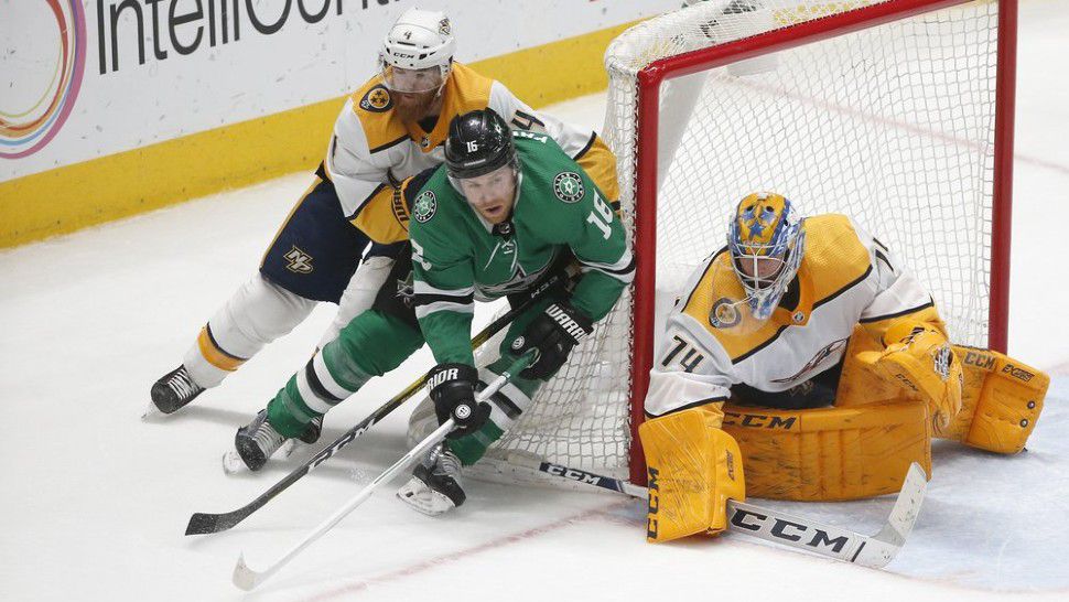 Dallas Stars center Joe Pavelski (16) moves the puck as Nashville Predators defenseman Ryan Ellis (4) and Nashville Predators goaltender Juuse Saros (74) defend the goal during the third period of an NHL hockey game Saturday, March 7, 2020, in Dallas. Nashville won 1-0. (AP Photo/Ron Jenkins)