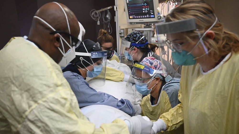 FILE - In this Monday, Dec. 7, 2020, file photo, critical care nurses and respiratory therapists flip a patient with COVID-19 upright at North Memorial Health Hospital in Robbinsdale, Minn. Virtually every state is reporting surges in cases and deaths. (Aaron Lavinsky/Star Tribune via AP, File)