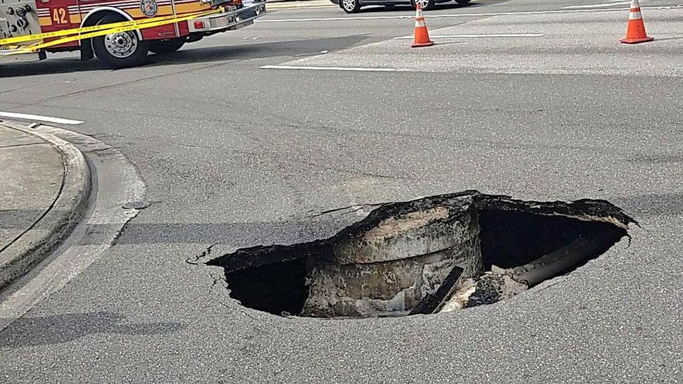 A large hole opened at the corner of Silver Star Road and Le Havre Boulevard on Monday. (Orange County Fire Rescue)