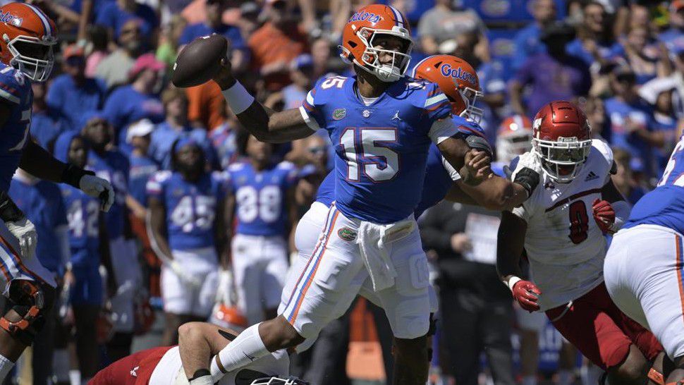 Florida quarterback Anthony Richardson (15) throws a pass for a completion while under pressure from Eastern Washington defensive lineman Brock Harrison during the first half of an NCAA college football game, Sunday, Oct. 2, 2022, in Gainesville, Fla. (AP Photo/Phelan M. Ebenhack)