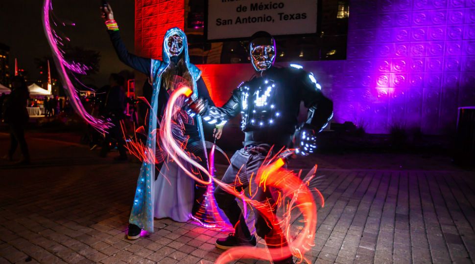An image of two people in illuminated costumes during Luminaria 2018 (Courtesy: Luminaria)