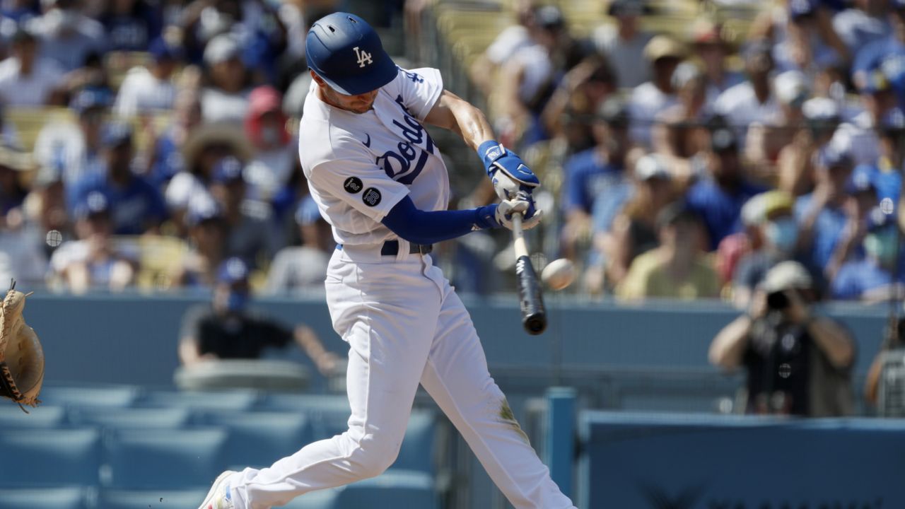 Los Angeles Dodgers' Trea Turner hits a grand slam home run against the Milwaukee Brewers during the fifth inning of a baseball game in Los Angeles, Sunday, Oct. 3, 2021. (AP Photo/Alex Gallardo)