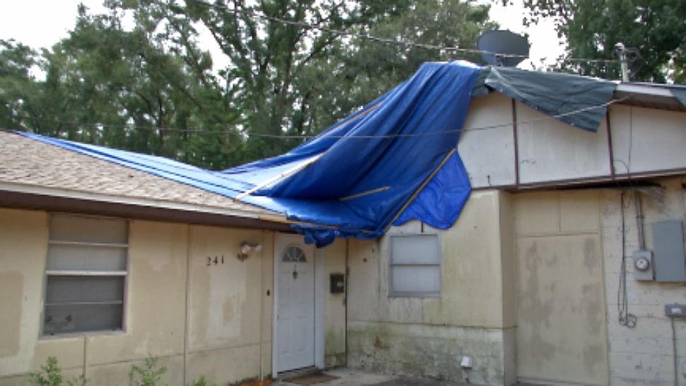 A Casselberry homeowner says her roof and much of her home remains in bad shape, and she’s had to replace the blue tarps on her home a dozen times in the last year. (Jeff Allen/Spectrum News 13)
