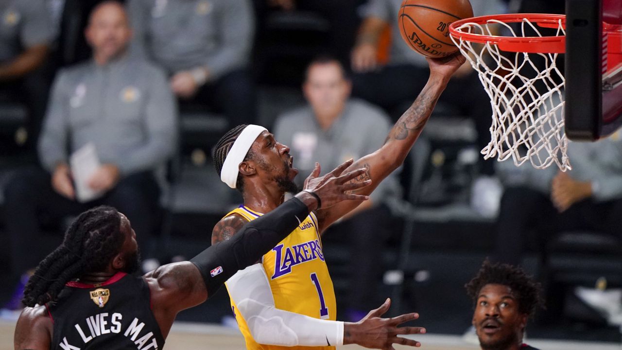 Los Angeles Lakers guard Kentavious Caldwell-Pope shoot around Miami Heat forward Jae Crowder during the first half in Game 4 of basketball's NBA Finals Tuesday, Oct. 6, 2020, in Lake Buena Vista, Fla. (AP Photo/Mark J. Terrill)