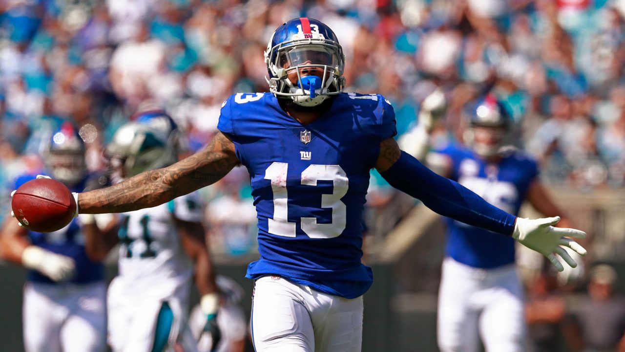 Odell Beckham Jr. holding a football.