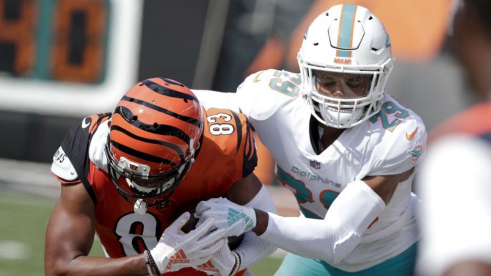 Miami Dolphins free safety Minkah Fitzpatrick (29) tackles Cincinnati Bengals wide receiver Tyler Boyd (83) after a catch during the first half of an NFL football game in Cincinnati, Sunday, Oct. 7, 2018. (AP Photo/Michael Conroy)