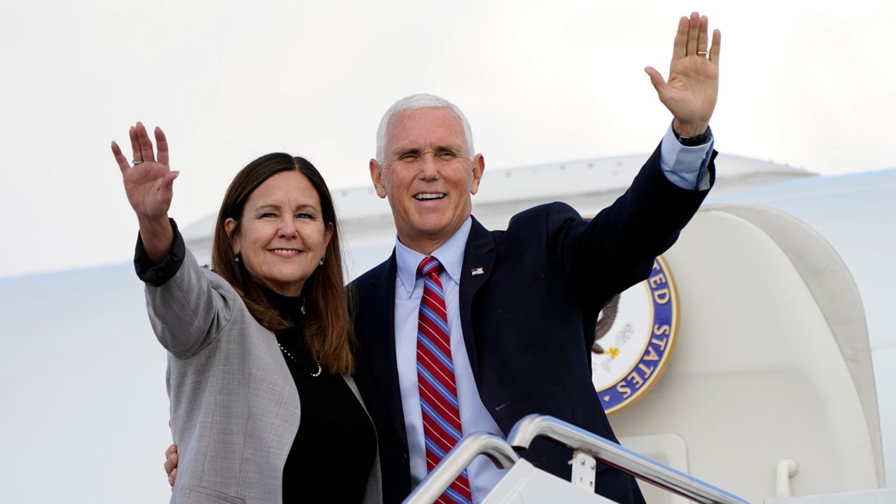 Vice President Mike Pence and his wife, Karen, wave as they board Air Force Two at Andrews Air Force Base, Maryland, on Monday, October 5, 2020, to head to Utah for the vice presidential debate scheduled for October 7. (Jacquelyn Martin/AP)