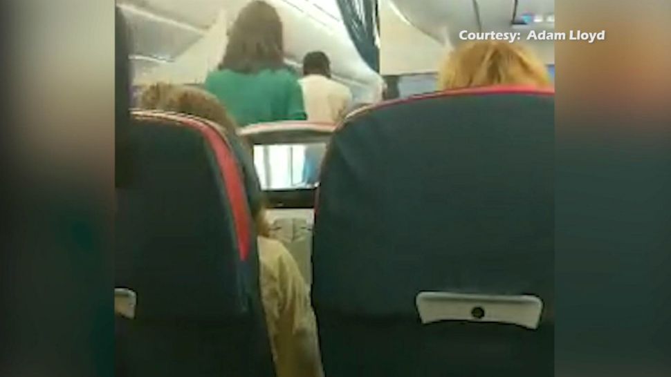 New video obtained by Spectrum News 13 shows Sylvia Rictor being escorted off a Delta flight at Orlando International Airport over the weekend after she was accused of not having a boarding pass or government-issued ID. (Courtesy of Adam Lloyd)
