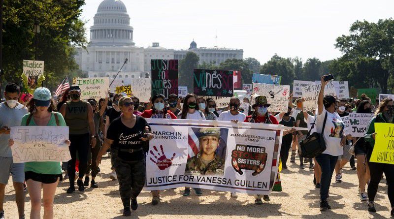 In this July 30, 2020 file photo, supporters of the family of slain Army Spc. Vanessa Guillen march to the White House along the National Mall as Capitol Hill is seen in the distance after a news conference, in Washington. (AP Photo/Carolyn Kaster, File)