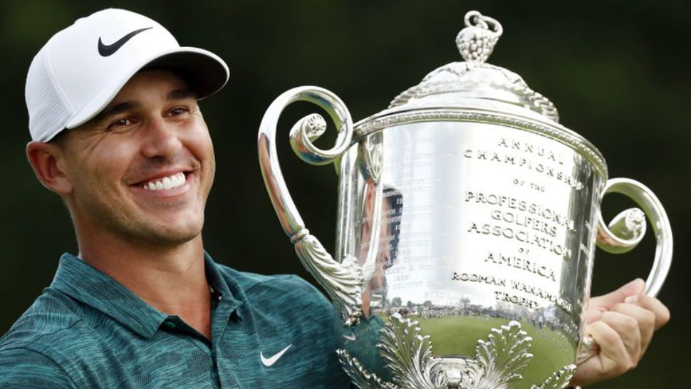FILE - In this Aug. 12, 2018, file photo, Brooks Koepka holds the Wanamaker Trophy after he won the PGA Championship golf tournament at Bellerive Country Club, in St. Louis. Koepka has won PGA Tour player of the year on the strength of his two major championships. (AP Photo/Brynn Anderson, File)