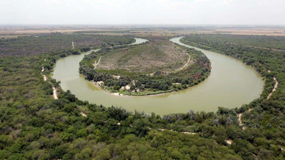 FILE - In this July 24, 2014, file photo, a bend in the Rio Grand is viewed from a Texas Department of Public Safety helicopter on patrol over in Mission, Texas. As hundreds of National Guard troops deploy to the U.S-Mexico border, residents of Texas' southernmost border region are fearful of the impact President Donald Trump's border wall will have. The troops patrolling the Rio Grande will eventually withdraw, but a wall could change the river forever. (AP Photo/Eric Gay, Pool, File)