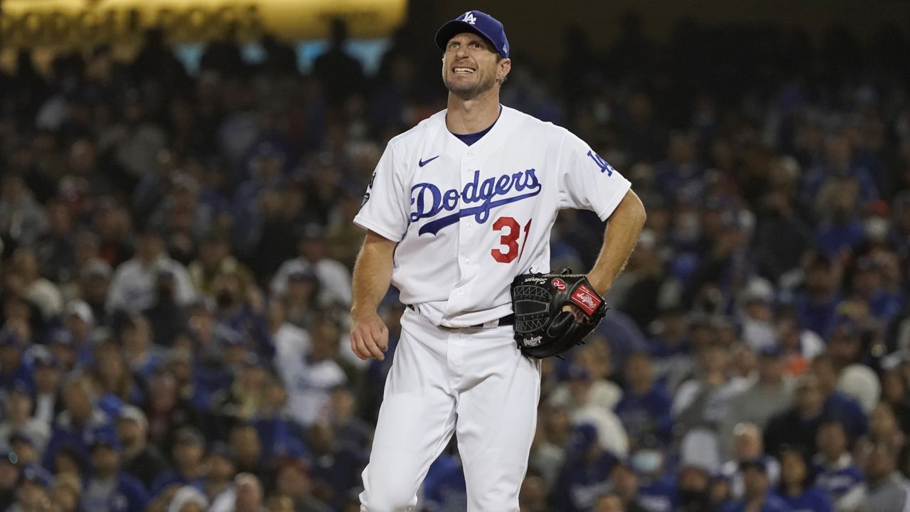 Los Angeles Dodgers starting pitcher Max Scherzer reacts after a pitch during the second inning of Game 3 of a baseball National League Division Series, Monday, Oct. 11, 2021, in Los Angeles. (AP Photo/Marcio Sanchez)