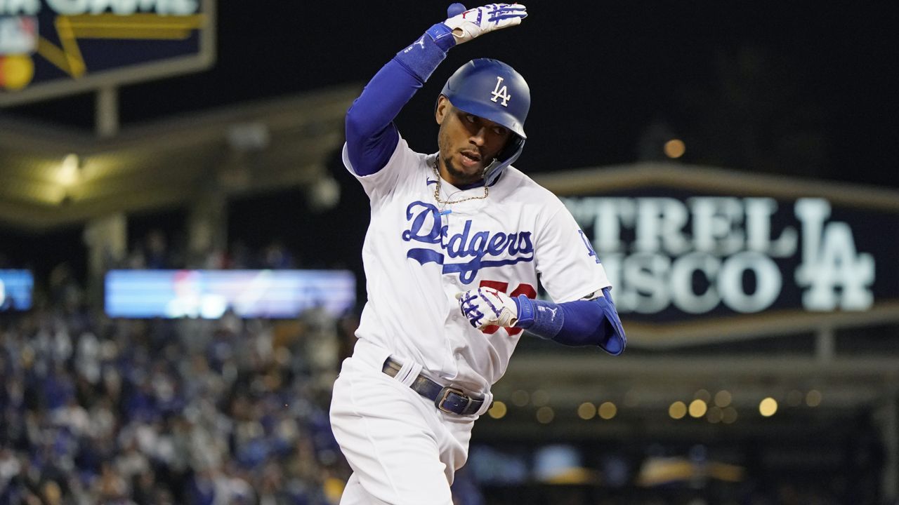 Los Angeles Dodgers' Mookie Betts celebrates as he runs the bases on a two-run home run during the fourth inning against the San Francisco Giants in Game 4 of a baseball National League Division Series, Tuesday, Oct. 12, 2021, in Los Angeles. (AP Photo/Marcio Jose Sanchez)