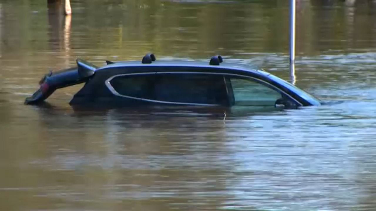 A car is in a flooded street in Florida after Hurricane Milton. (Spectrum News)