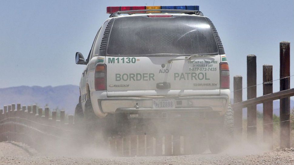 FILE - In this May 26, 2006 photo, a U.S. Border Patrol agent patrols the international border separating Sonoyta, Mexico, right of fence and Lukeville, Ariz. (AP Photo/Matt York)