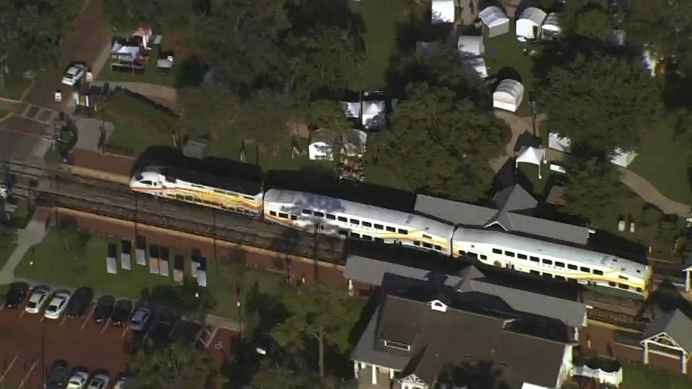 A SunRail train sits idle on tracks in Winter Park after a bicyclist was struck Friday afternoon. (Sky 13)