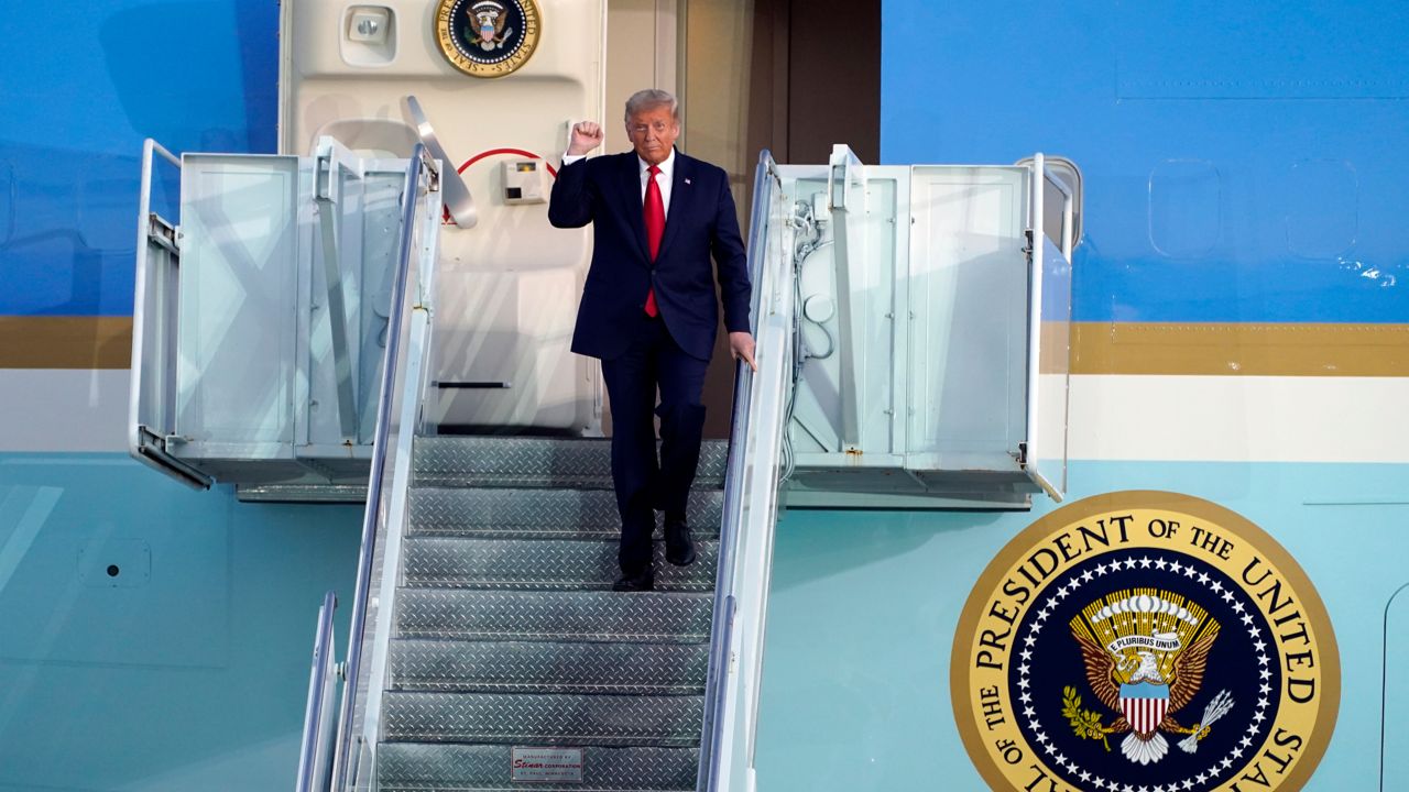 President Donald Trump reacts to the crowd as he arrives to speak at a campaign rally at Orlando Sanford International Airport on Monday, October 12, 2020, in Sanford, Florida. (Evan Vucci/AP)