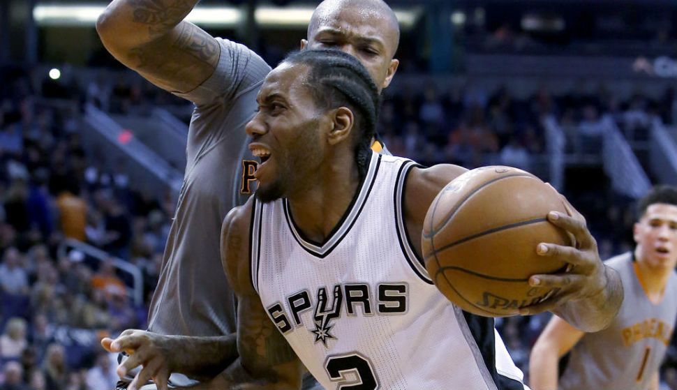 San Antonio Spurs forward Kawhi Leonard (2) drives on San Antonio Spurs guard Jonathon Simmons in the second quarter during an NBA basketball game, Thursday, Jan. 21, 2016, in Phoenix. (AP)