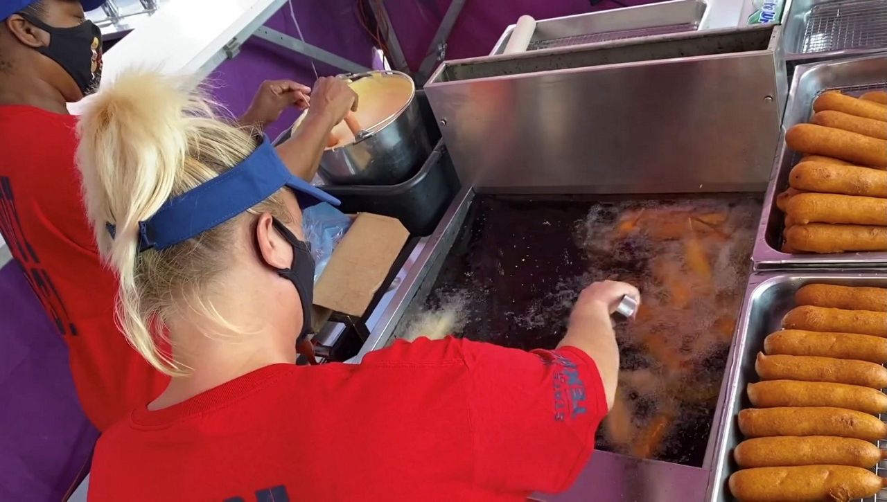 Cooks at Fletcher’s Corny Dog deep fry the Texas treat (Spectrum News)