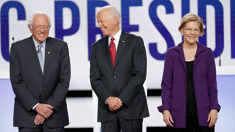 Sen. Bernie Sanders, former Vice President Joe Biden, and Sen. Elizabeth Warren, left to right, stand on stage before their Democratic debate in Westerville, Ohio, on October 15. (John Minchillo/AP)