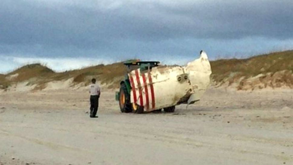 Debris from a SpaceX rocket washed ashore near the Outer Banks of North Carolina late last week. National Park Service workers are seen removing the debris Monday.