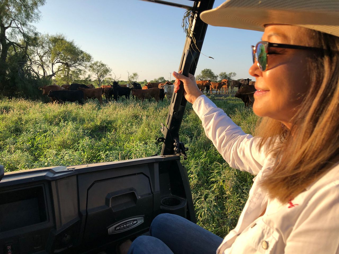 Stephanie Martinez looks out on the ranch while her husband drives. (Spectrum News)