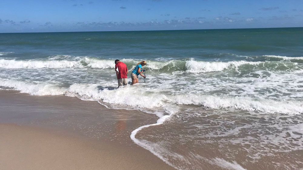 Officials test for Florida Red Tide in Melbourne Beach Tuesday. (Greg Pallone, Spectrum News)