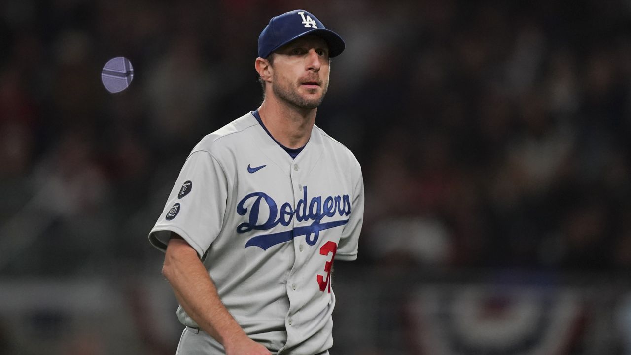Los Angeles Dodgers starting pitcher Max Scherzer walks off the field after being relieved in the fifth inning in Game 2 of baseball's National League Championship Series against the Atlanta Braves Sunday, Oct. 17, 2021, in Atlanta. (AP Photo/Brynn Anderson)