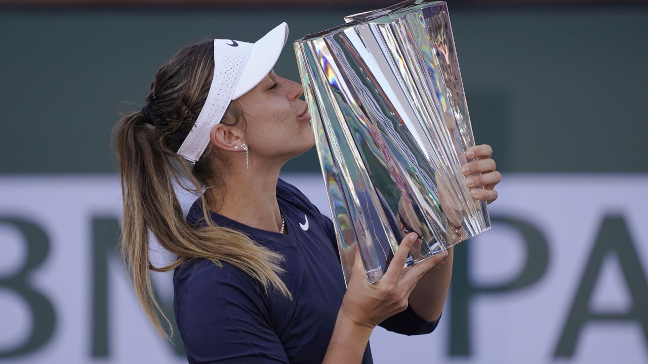 Paula Badosa, of Spain, kisses her trophy after defeating Victoria Azarenka, of Belarus, in the singles final at the BNP Paribas Open tennis tournament Sunday, Oct. 17, 2021, in Indian Wells, Calif. (AP Photo/Mark J. Terrill)