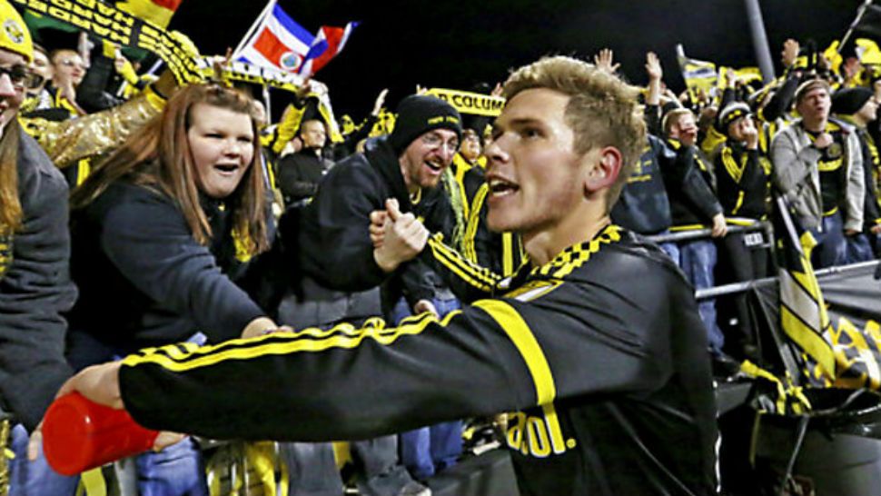 In this Nov. 8, 2015, file photo, Columbus Crew midfielder Wil Trapp (20) celebrates with fans after the Crew won their MLS playoff soccer game against the Montreal Impact at Mapfre Stadium in Columbus, Ohio. (Fred Squillante/The Columbus Dispatch via AP, File)