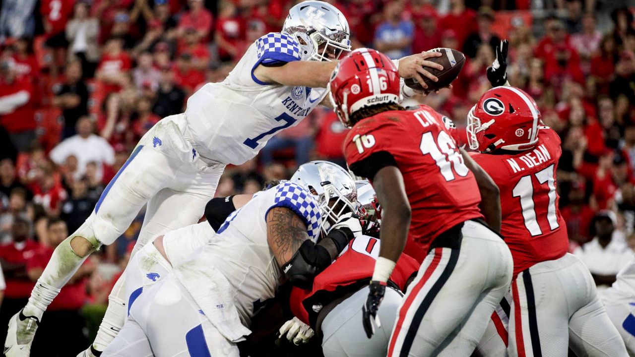 Kentucky quarterback Will Levis (7) is stopped short of the goal line by Georgia linebacker Nakobe Dean (17) during the second half of an NCAA college football game Saturday, Oct. 16, 2021 in Athens, Ga. (AP Photo/Butch Dill)