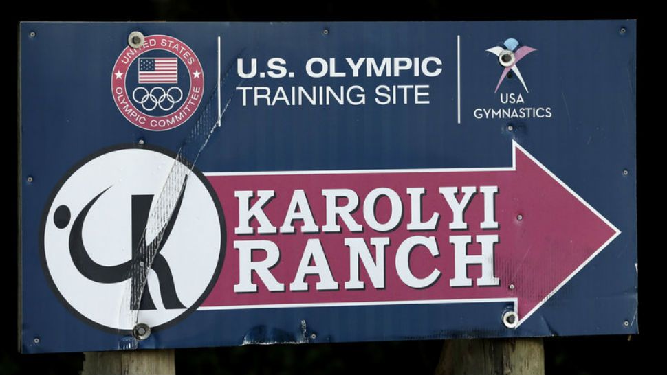 In this Sept. 12, 2015 file photo a sign points down to Karolyi Ranch near New Waverly, Texas. (AP Photo/David J. Phillip, File)