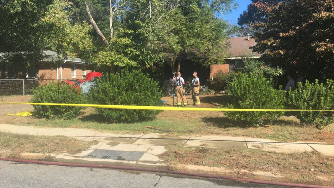 Investigators and fire crews outside of the home. 