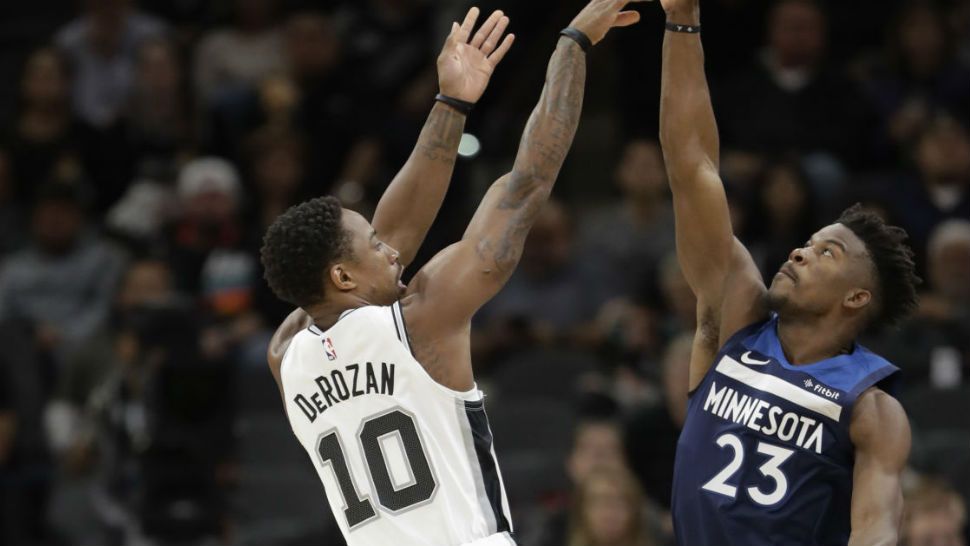 San Antonio Spurs guard DeMar DeRozan (10) shoots over Minnesota Timberwolves guard Jimmy Butler (23) during the first half of an NBA basketball game, Wednesday Oct. 17, 2018, in San Antonio. (AP Photo/Eric Gay)